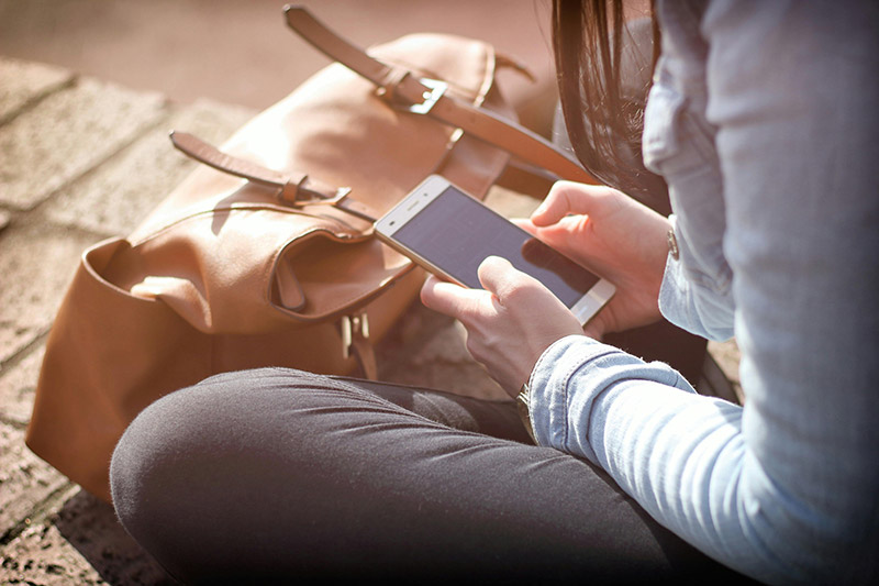 female holding a smartphone