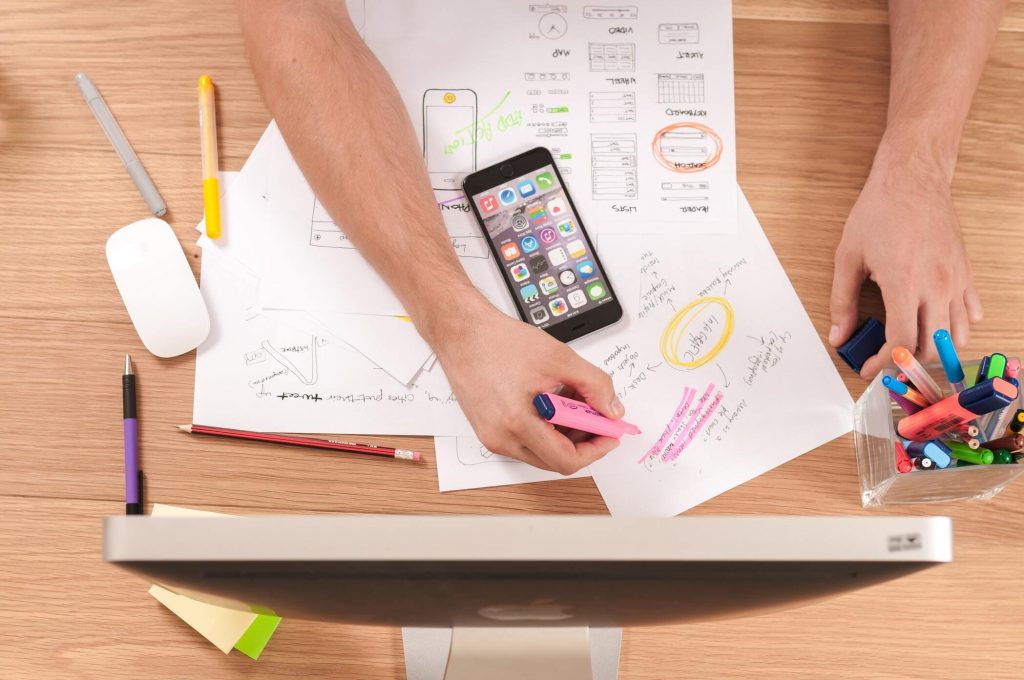A person's hands working with paper and writing utensils. A computer stands on the desk.
youtube seo 2022