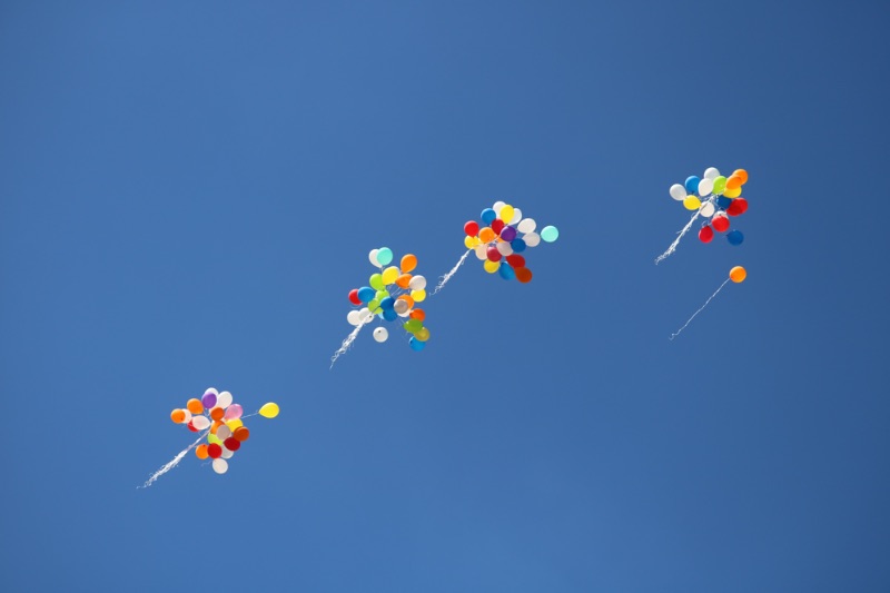Balloons released into sky stock image