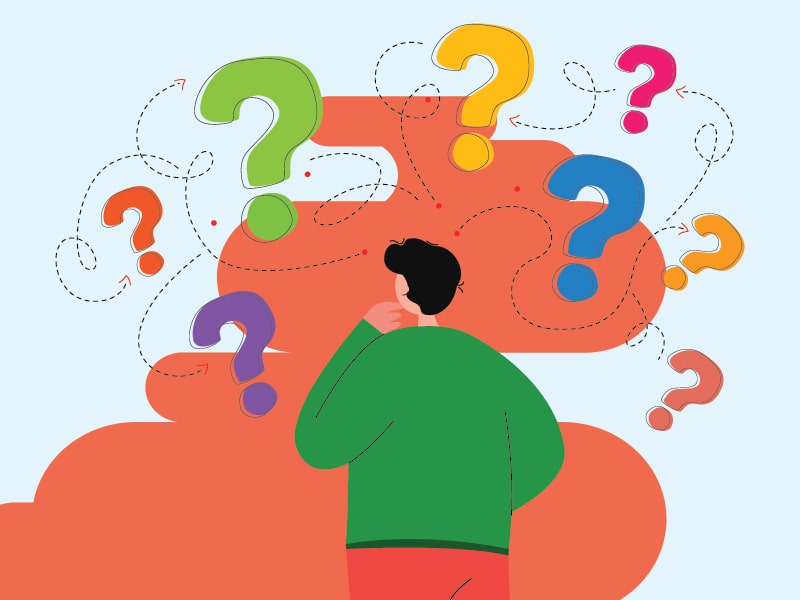 man looking up at question marks