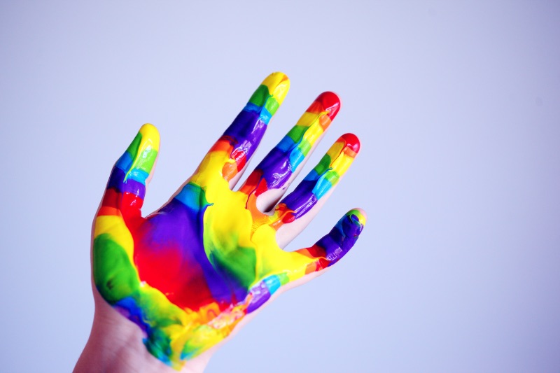 Hand covered in rainbow paint