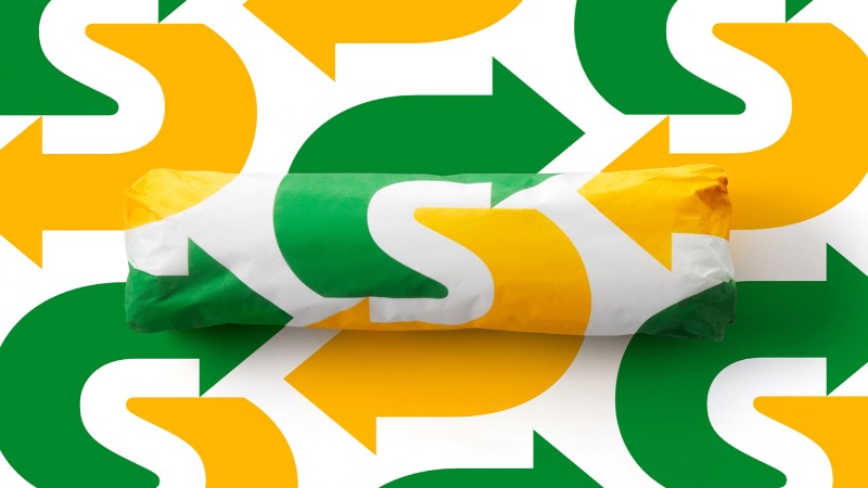 Subway wrapper against a backdrop of their redesigned S logo created by Turner Duckworth