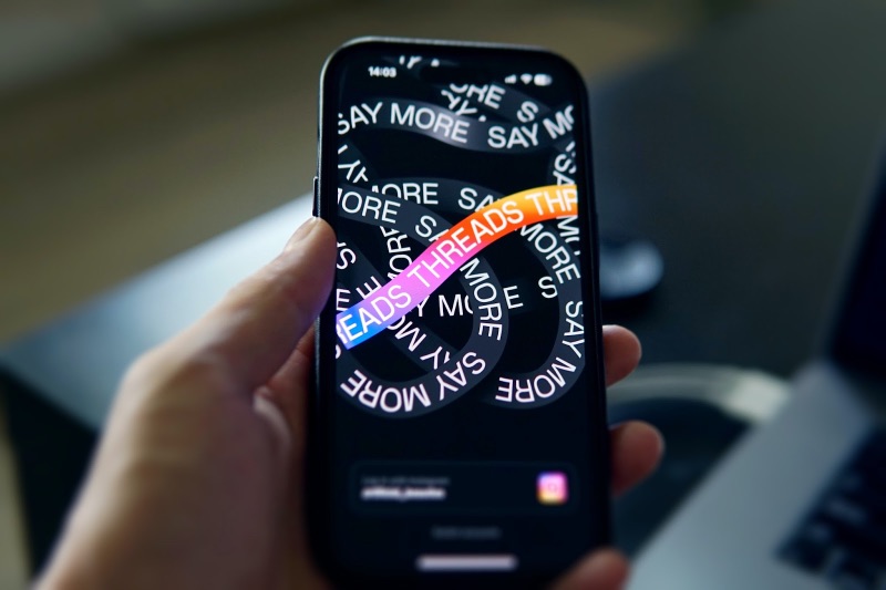 Person holding a phone with the app welcome page open