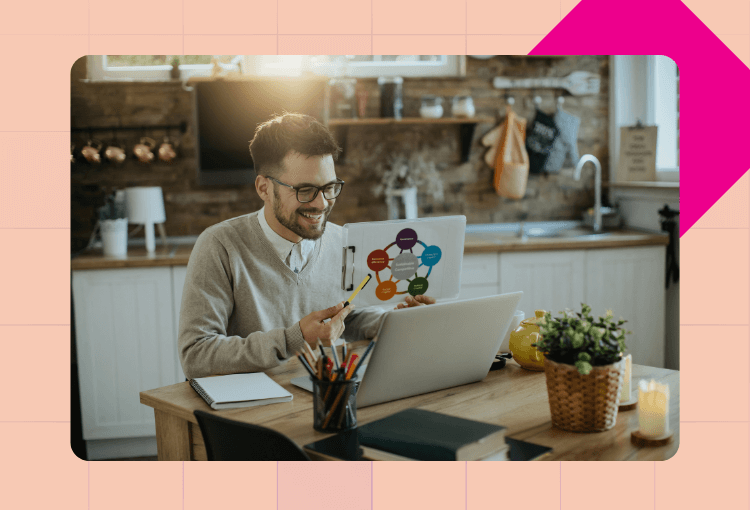 a smiling man working on a laptop with infographic design service