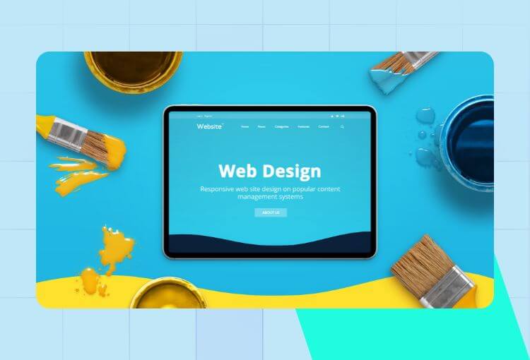Website graphic design services with tablet, paint and paintbrushes